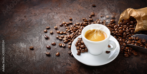 Espresso and coffee beans on plaster background