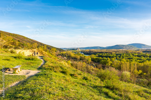 View of Devin castle from Sandberg hill. Beautiful spring evening with green grass and blue sky. Look to old historical fortress