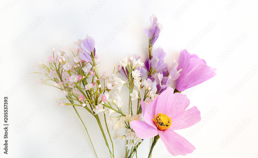 Obraz premium Three artificial flowers on white background