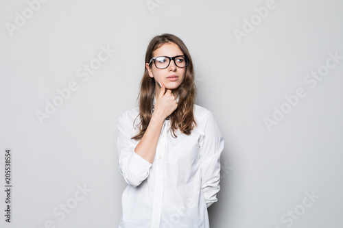 Beautiful thinking business woman isolated gray background photo