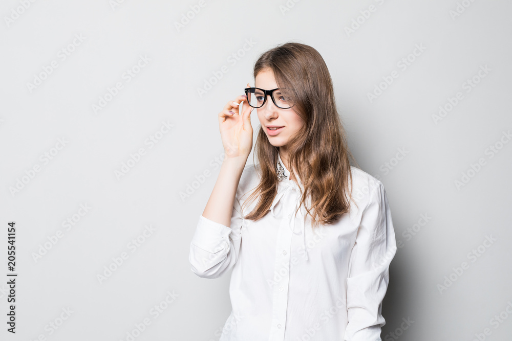 Closeup profile of confident business woman looking forward isolated on gray Closeup profile of confident business woman looking forward isolated on gray
