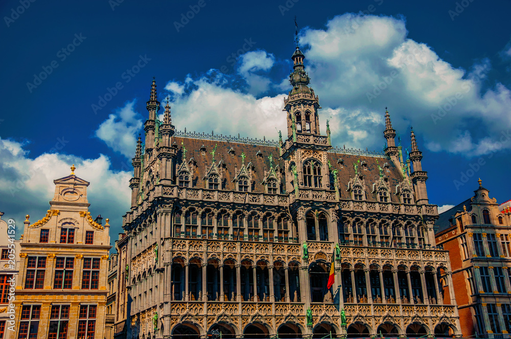 Richly decorated facade in Gothic style of Brussels City Museum and Belgian flag. Vibrant and friendly, is the country’s capital and administrative center of the EU. Central Belgium. Retouched photo