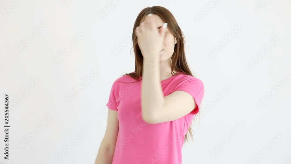 beautiful cheerful girl in sunglasses, pink top and jeans posing against white wall beautiful cheerful girl in sunglasses, pink top and jeans posing against white wall