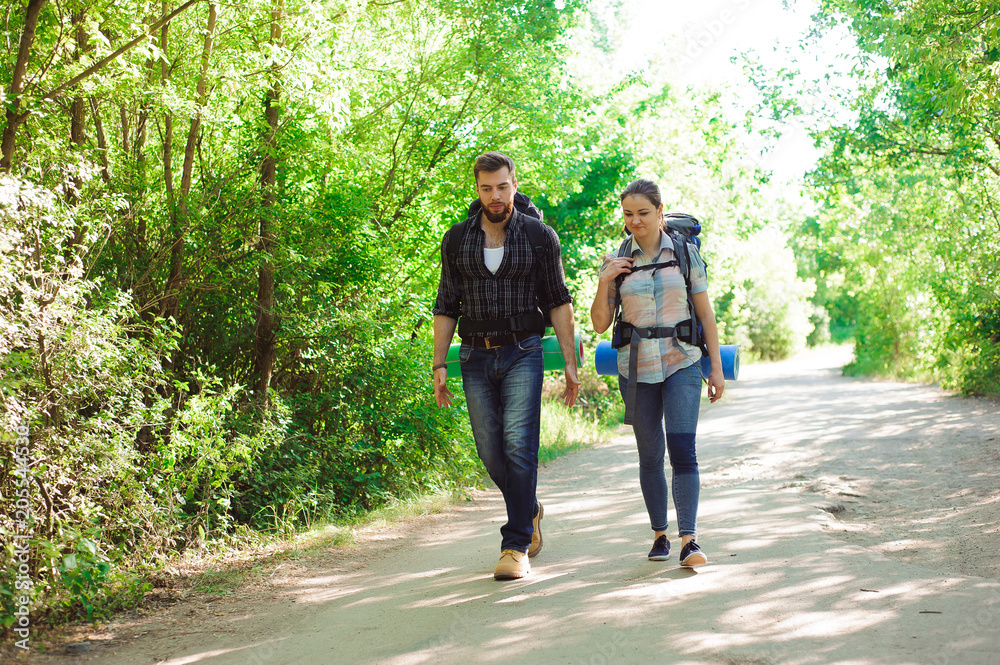 A young couple is traveling with backpacks A young couple is traveling with backpacks