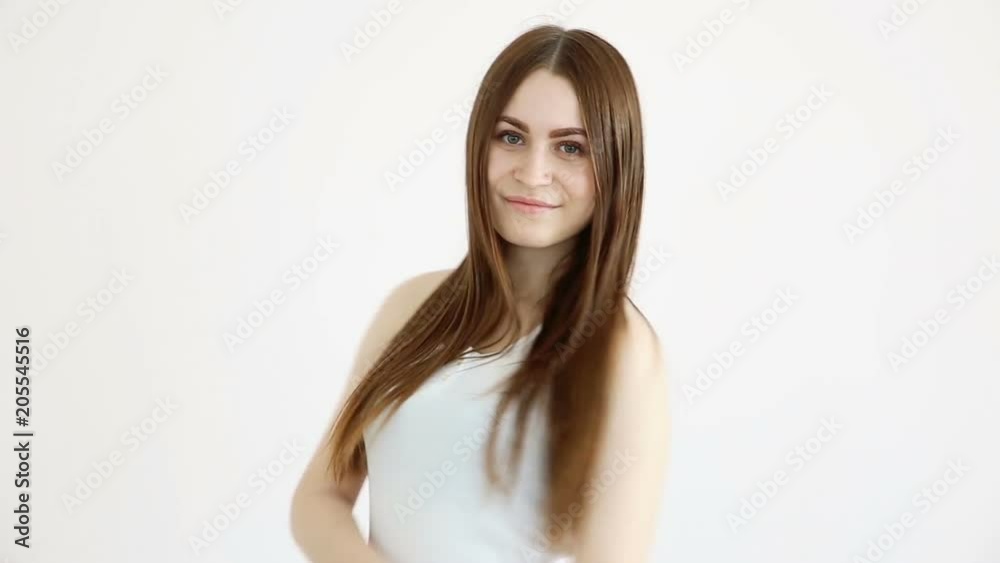 beautiful happy girl posing positively against a white wall and blowing kisses beautiful happy girl posing positively against a white wall and blowing kisses
