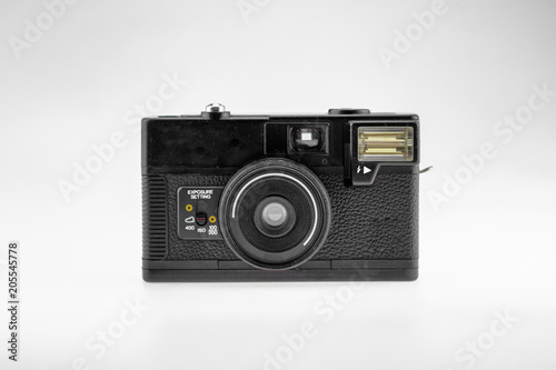 Old fashioned vintage style film camera for professional photography is a retro fashion look on a white background isolated.