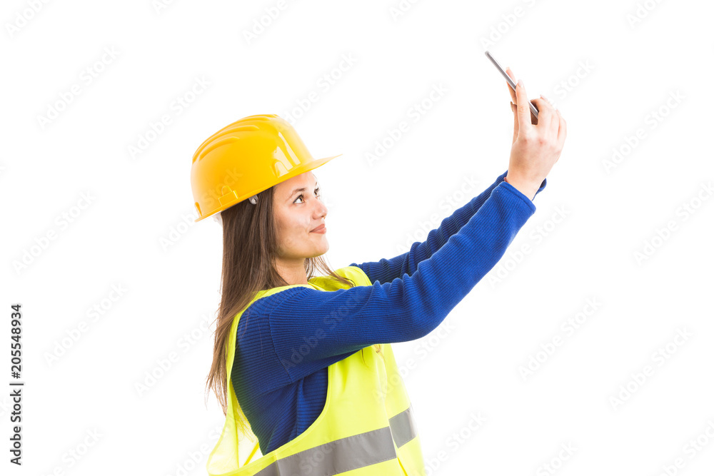 Young attractive female architect taking a selfie. Young attractive female architect taking a selfie.