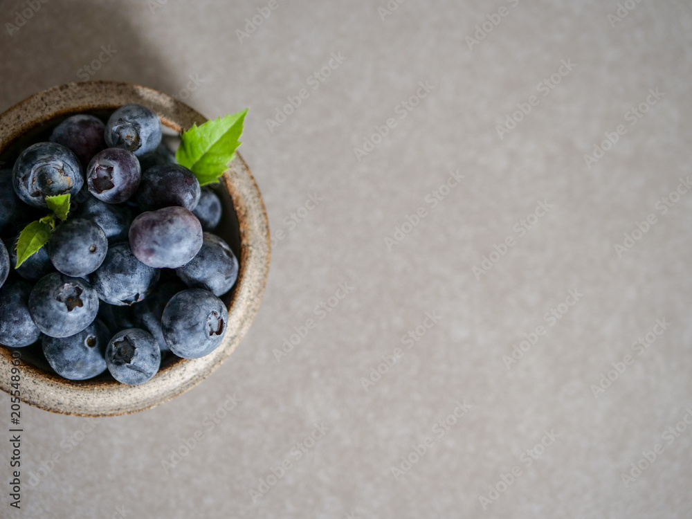 Fresh blueberries, in a ceramic bowl, on a gray background Fresh blueberries, in a ceramic bowl, on a gray background