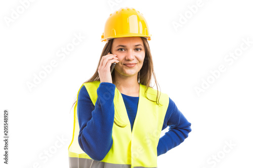 Young woman architect using smartphone.