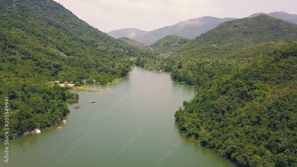 Beautiful river with stones among green mountains covered tropical forest. Natural landscape river and high green mountain from flying drone. Beautiful river with stones among green mountains covered tropical forest. Natural landscape river and high green mountain from flying drone.
