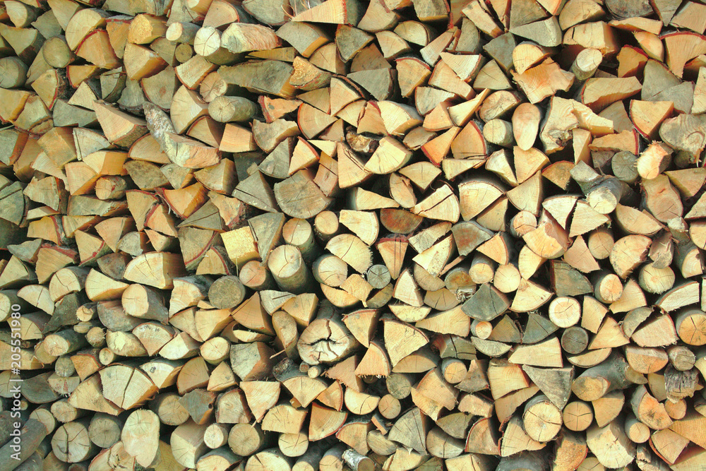 chopped logs stacked on top of each other chopped logs stacked on top of each other