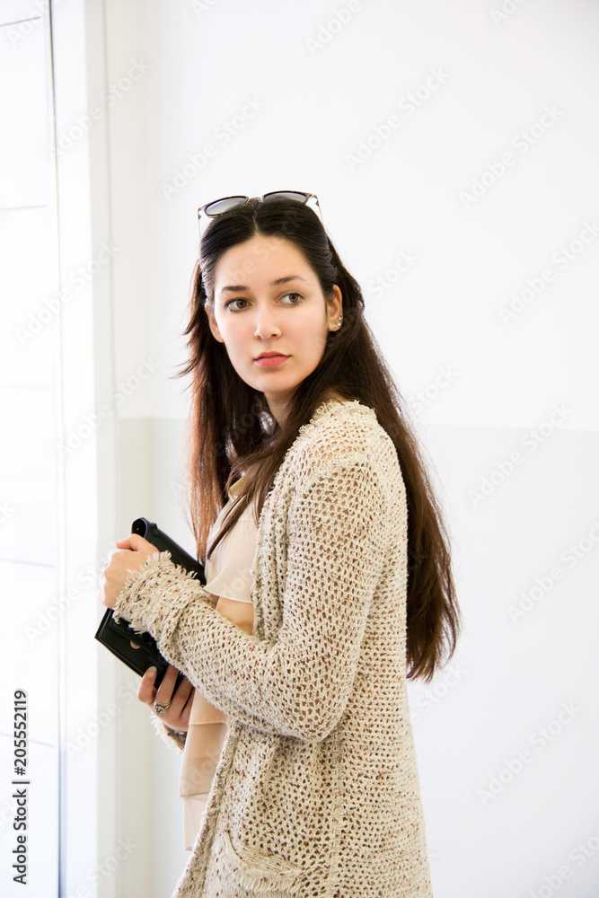 young woman with beige knitted cotton long cardigan young woman with beige knitted cotton long cardigan
