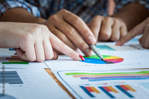 Business team work brainstroming meeting process. Business people discussing the charts and graphs showing the results of their successful teamwork. photo