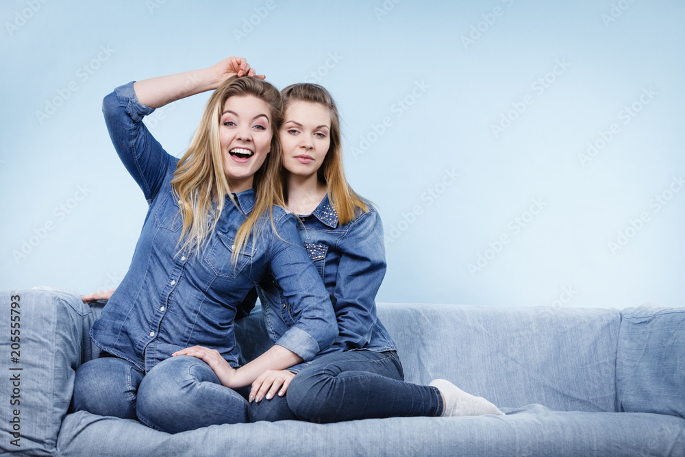 Two happy women friends wearing jeans outfit Two happy women friends wearing jeans outfit