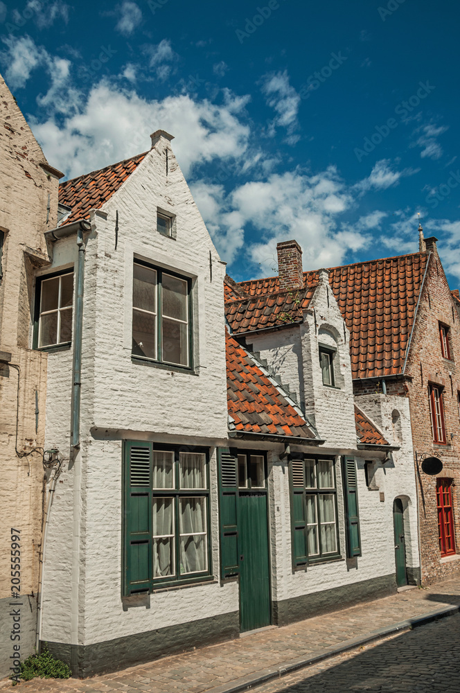 Brick facade of houses in typical style of the Flanders’s region in street of Bruges. With many canals and old buildings, this graceful town is a World Heritage Site of Unesco. Northwestern Belgium. Brick facade of houses in typical style of the Flanders’s region in street of Bruges. With many canals and old buildings, this graceful town is a World Heritage Site of Unesco. Northwestern Belgium.