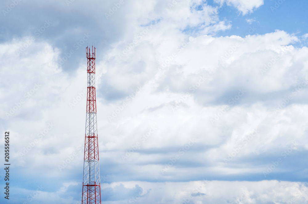 Mobile telecommunication tower with communication antennas in the background of dense clouds Mobile telecommunication tower with communication antennas in the background of dense clouds