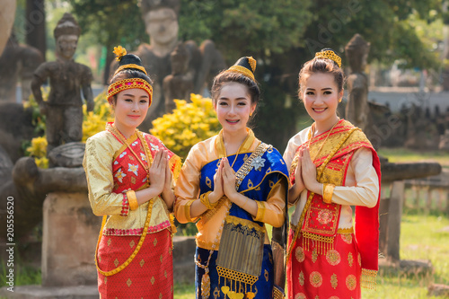 Beautiful girl in Laos costume,Asian woman wearing traditional Laos culture at temple.Vintage style.