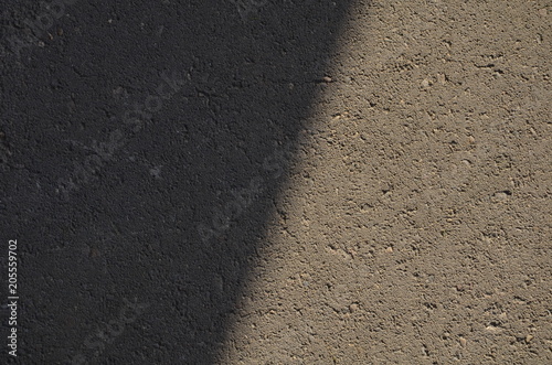  Shadow on the road, Texture of the concrete road, Road at sunset, Abstract surface. Close up the darkness, Concrete texture, shadow line. Space for text.