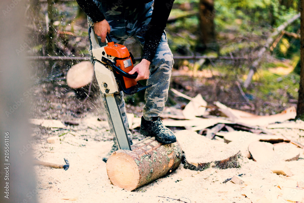 Close up shot of man working with chainsaw Close up shot of man working with chainsaw