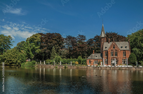 Amazing lake surrounded by greenery and old brick building on the other side in Bruges. With many canals and old buildings, this graceful town is a World Heritage Site of Unesco. Northwestern Belgium. © Celli07