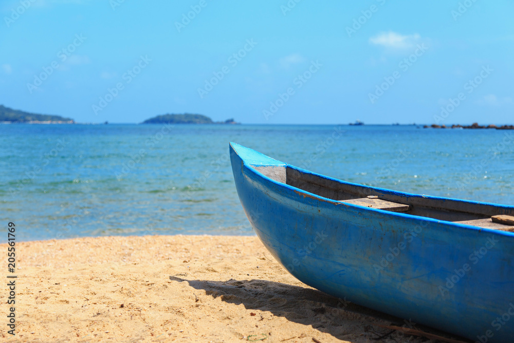 fishery, blue fishing wooden boat on the tropical coast