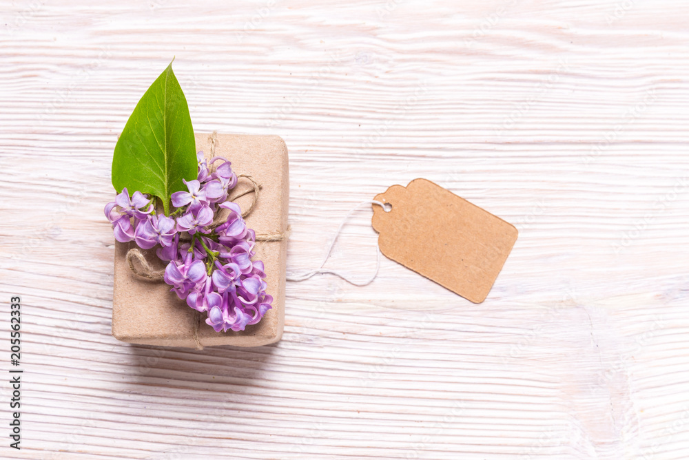 Gift box with lilac flowers on wood backgroubd Gift box with lilac flowers on wood backgroubd