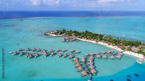 Aerial view of tropical paradise of Bora Bora island, turquoise crystal clear water of scenic blue lagoon, typical over water bungalows, Matira Point - South Pacific Ocean, French Polynesia from above photo