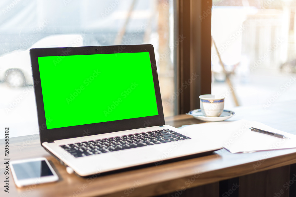 Green screen of Mockup image of laptop with blank screen on wooden table. Green screen of Mockup image of laptop with blank screen on wooden table.