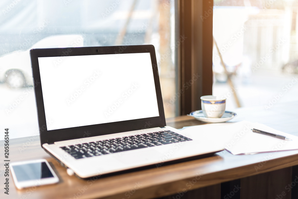Mockup image of laptop with blank white screen and Smartphone on wooden table of In the coffee shop. Mockup image of laptop with blank white screen and Smartphone on wooden table of In the coffee shop.