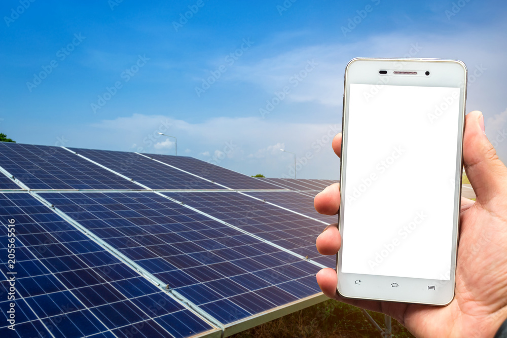 Men use smartphone blurred images in the solar panel background. As Renewable Energy and clean energy.