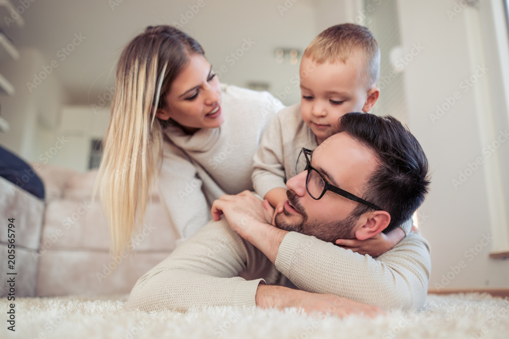 Happy young family having great time at home