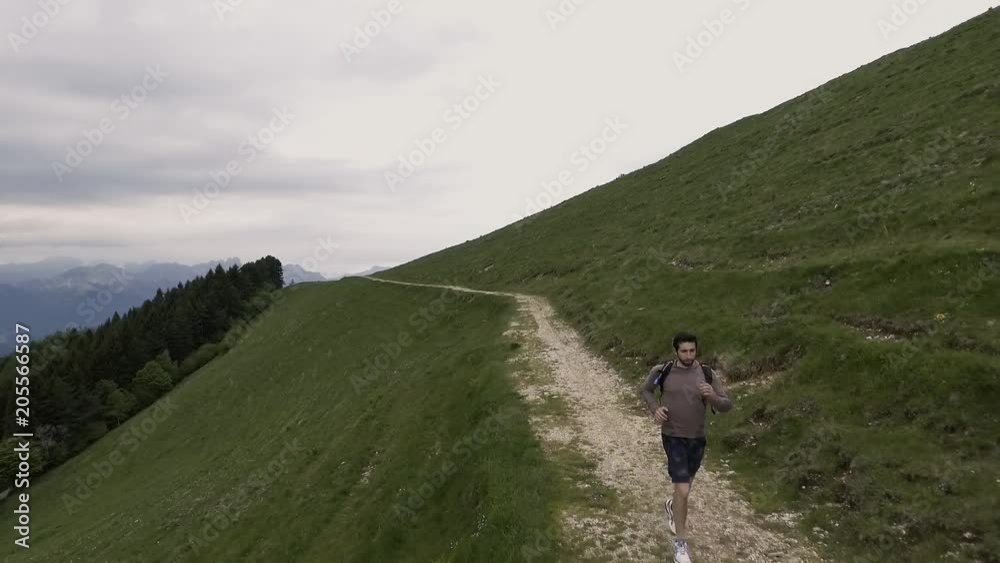 Young athletic man exploring mountains and running Young athletic man exploring mountains and running