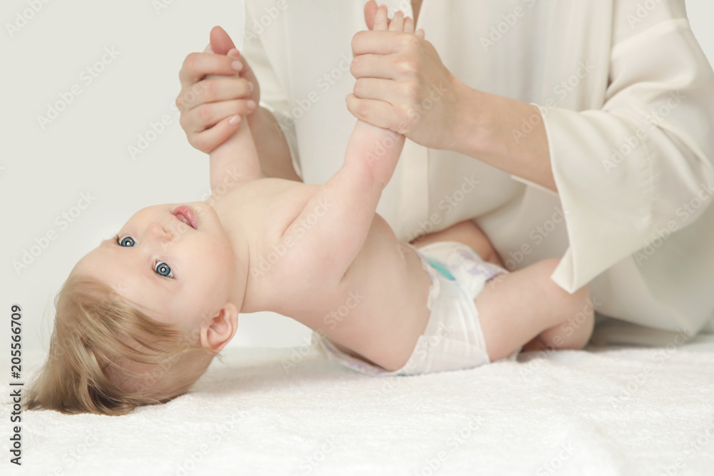 Mother massaging baby hands and doing exercise after bath Mother massaging baby hands and doing exercise after bath