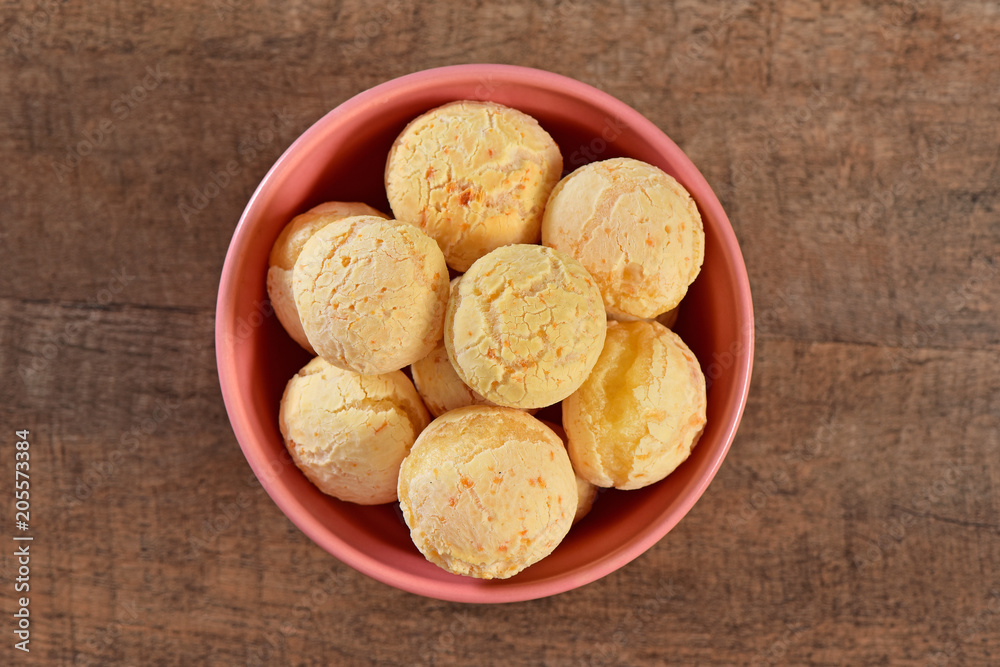 Cheese breads on pink bowl and wooden background Cheese breads on pink bowl and wooden background