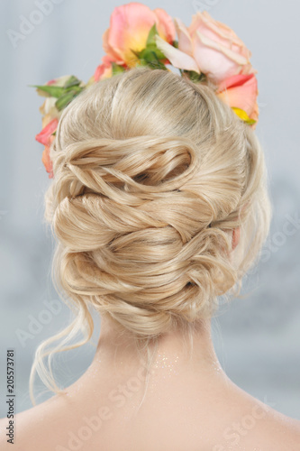 Blonde girl with elegant wedding hairstyle view from behind.