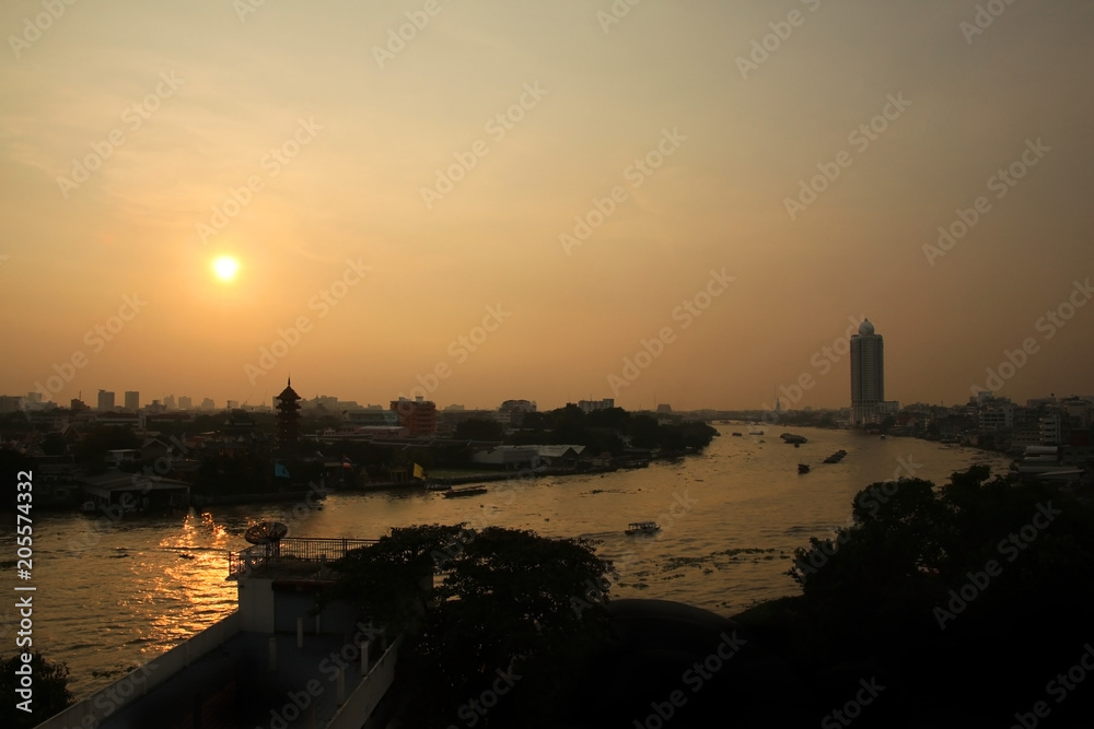 Sunset over the Chao phraya river in central Bangkok, Thailand.