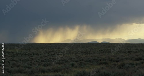 Rain showers pass over distant mountains sagebrush photo