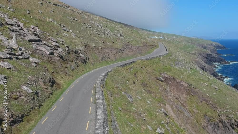 Amazing winding street along the coast line of Dingle Peninsula in Ireland - aerial shot Amazing winding street along the coast line of Dingle Peninsula in Ireland - aerial shot