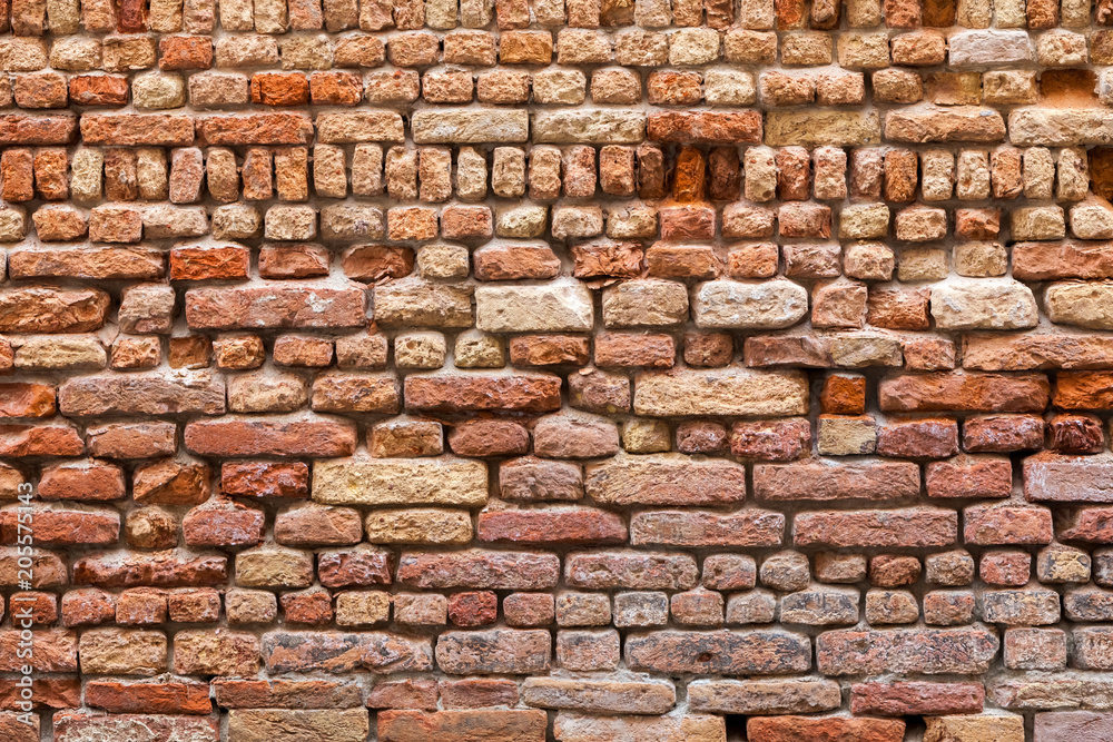 Fototapeta premium Old vintage brickwall built by random pattern with different sizes of bricks