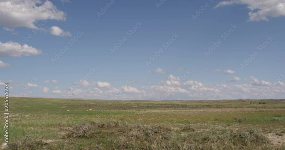 Wide pan of Montana prairie with blue skies and clouds Wide pan of Montana prairie with blue skies and clouds
