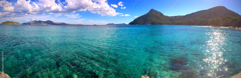 Panorama of a crystal clear blue ocean at Playa de Formentor, Mallorca, Spain Panorama of a crystal clear blue ocean at Playa de Formentor, Mallorca, Spain