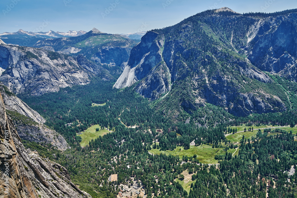 View of the Yosemite Valley with Visitor Center and the Sierra Nevada mountain range from the trail to Upper Yosemite Falls