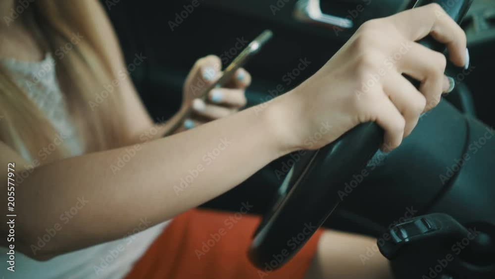 young woman using social network app on her smartphone in a car. young woman using social network app on her smartphone in a car.
