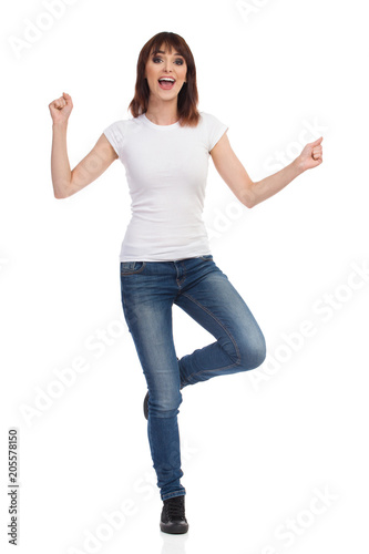 Happy Young Woman Is Standing On One Leg Cheering And Shouting