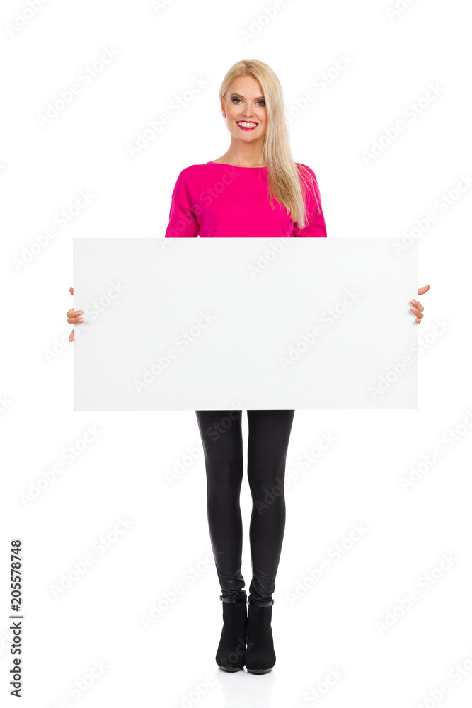 Smiling Beautiful Blond Woman Is Holding Empty Poster Smiling Beautiful Blond Woman Is Holding Empty Poster