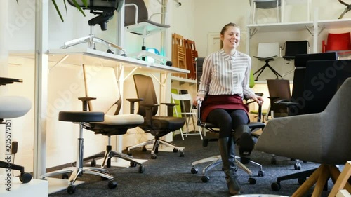 Wallpaper Mural Satisfied young woman sitting in ergonomic office chair in furniture store before buying
 Torontodigital.ca