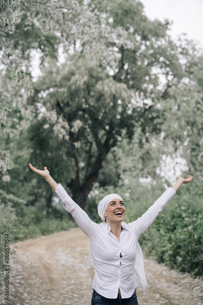 woman with white headscarf in the forest, has cancer woman with white headscarf in the forest, has cancer