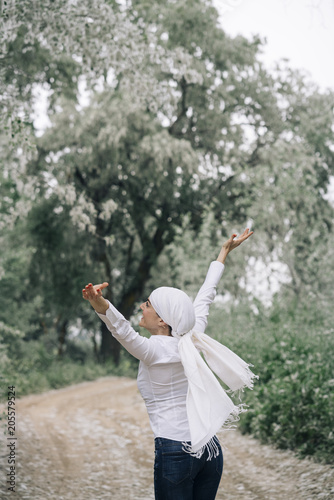 woman with white headscarf in the forest  has cancer