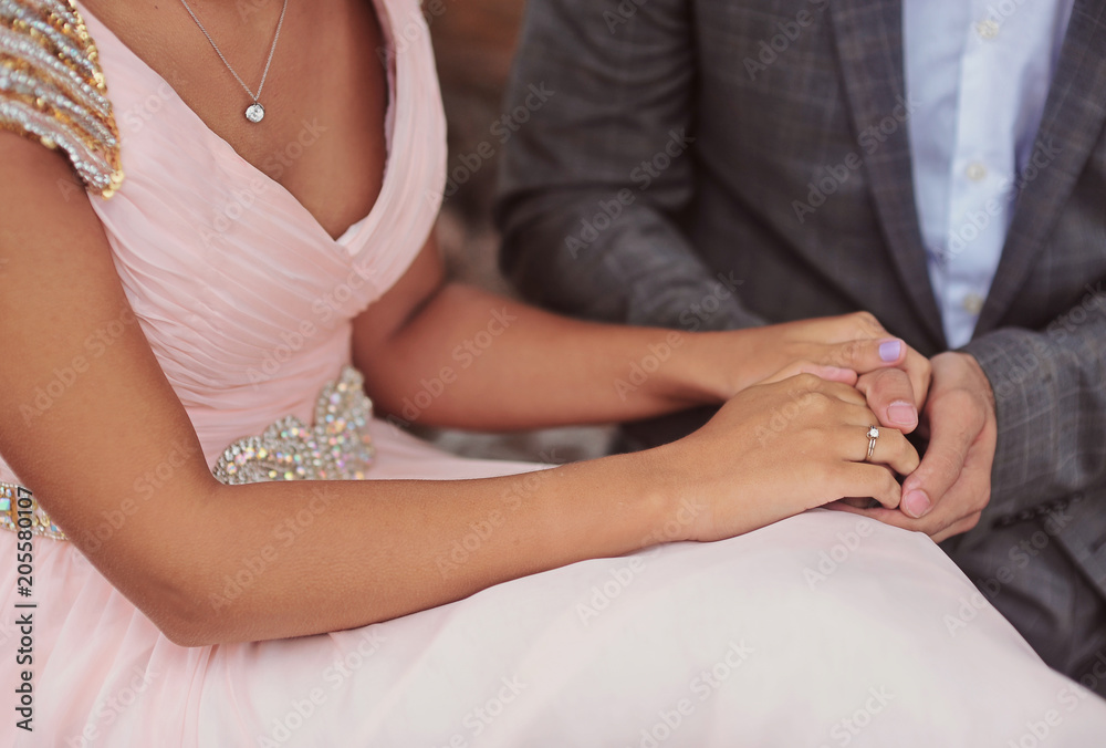 Hands of newlyweds or young lovely couple. Pair of lovers hands close up. Love together concept Hands of newlyweds or young lovely couple. Pair of lovers hands close up. Love together concept