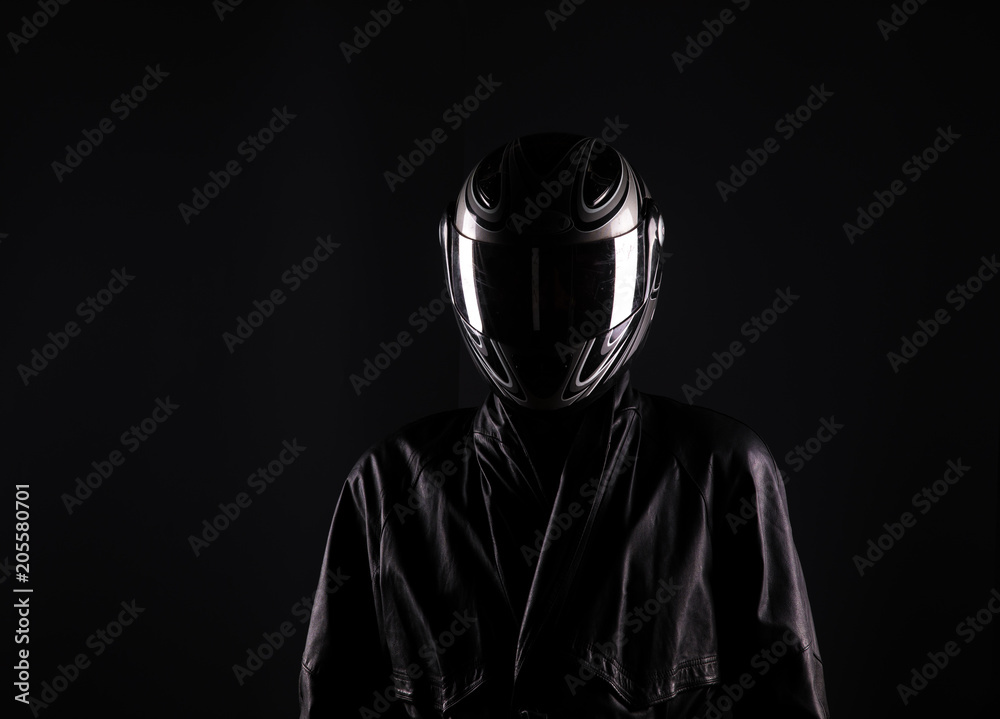 biker in helmet on a black background